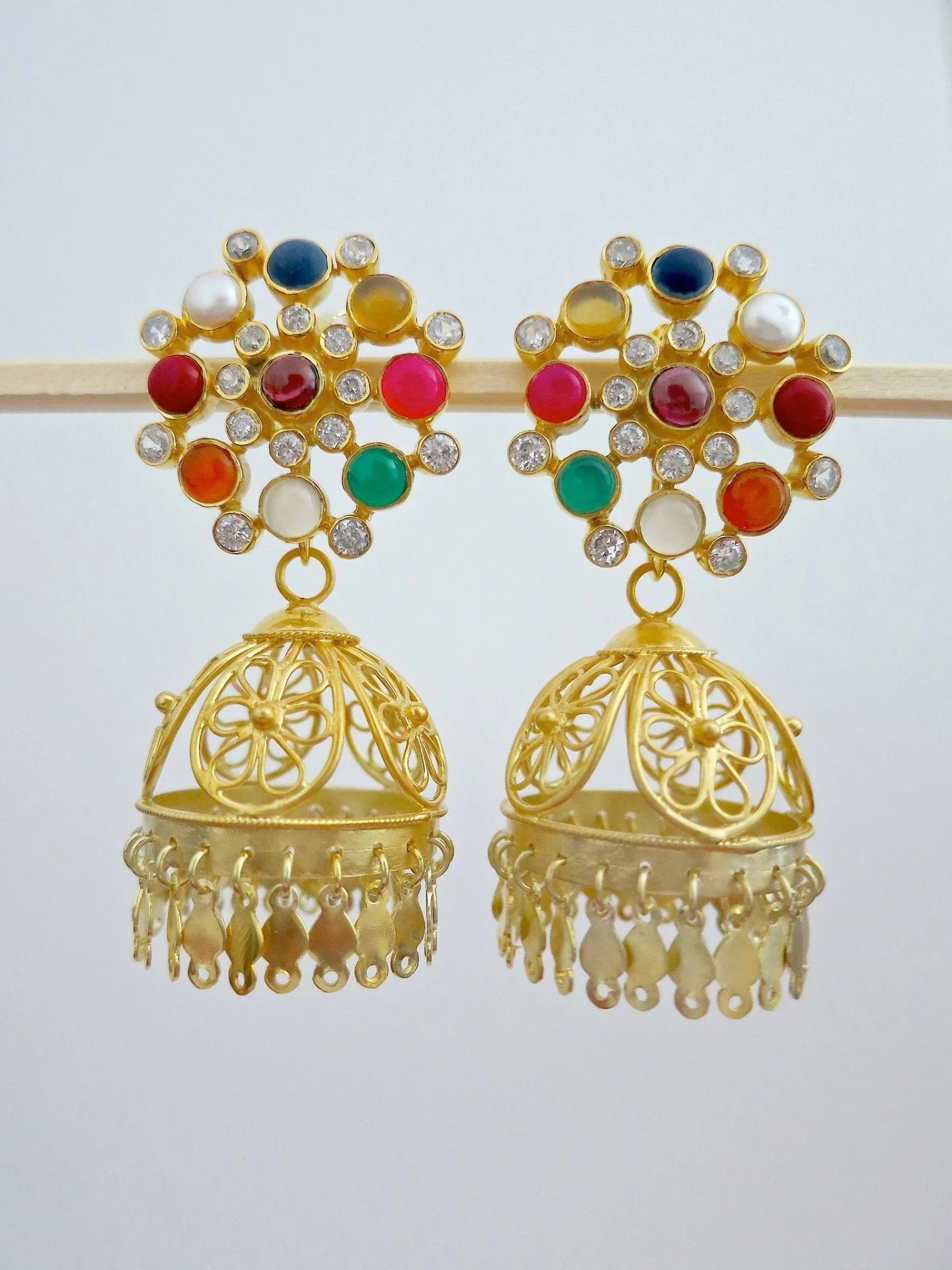 Glamorous, gold-plated, detachable filigree jhumkas with round multi-color gemstone tops