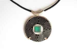 Gorgeous, large round pendant with fine black enamel work and a faceted chrysoprase